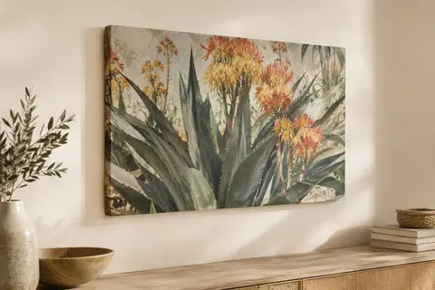 Tableau sur toile botanique représentant des feuilles d’agave et des fleurs, avec ses bords imprimés visibles.